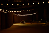 Outdoor patio with string lights and picnic tables styled with 90s themed tablecloths.