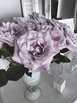 Collection of commemorative event favors in purple and pink, displayed with a soft-focus background.