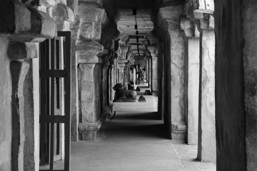 a black and white photo of a long hallway