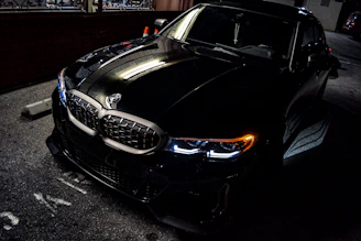 a black car parked on the side of the road