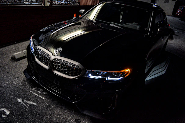 a black car parked on the side of the road