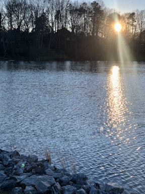 A serene view of the Bio Bio riverbank with mining equipment quietly resting nearby at sunset.
