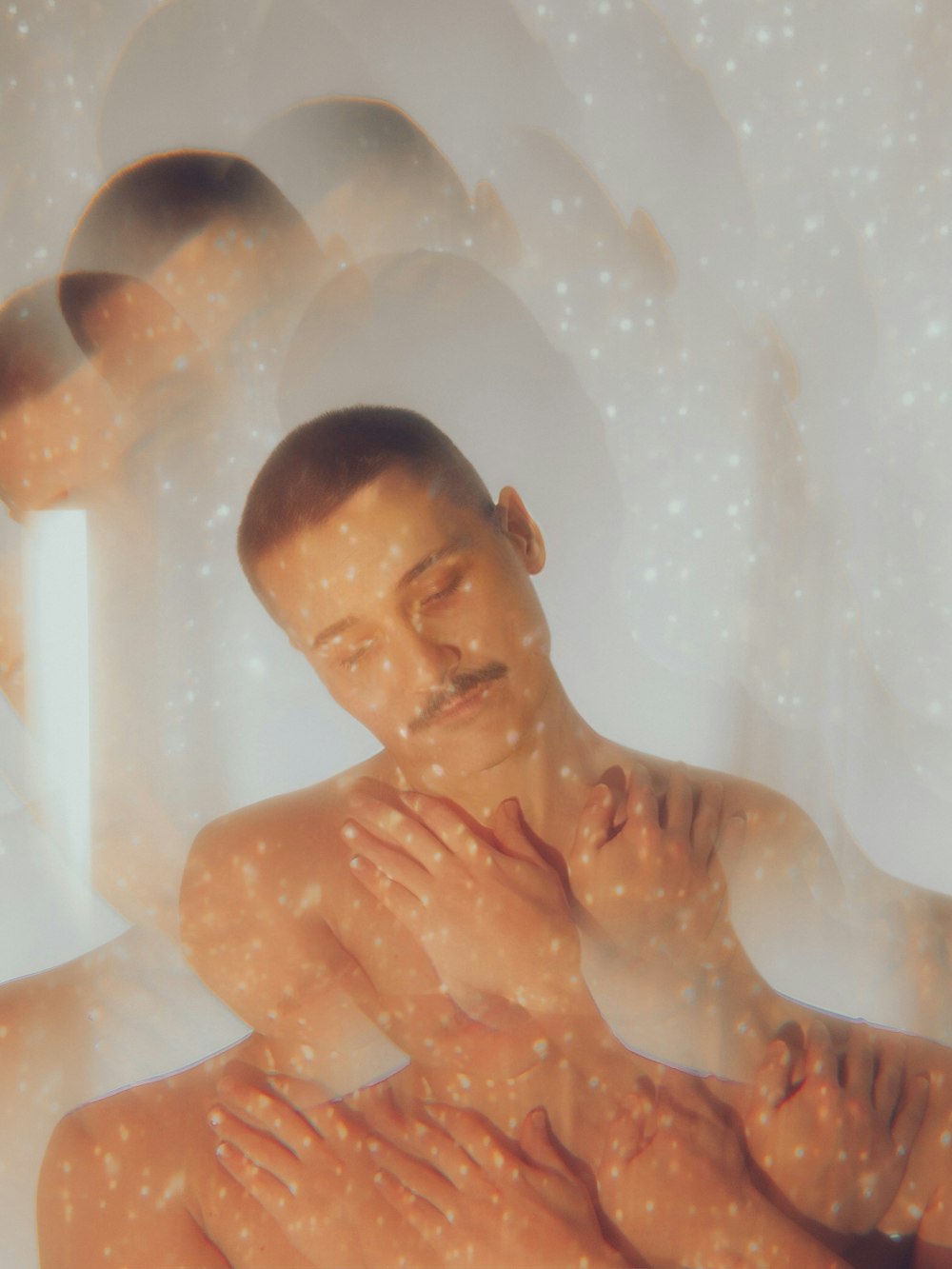 a man sitting in a bathtub with his hands on his chest