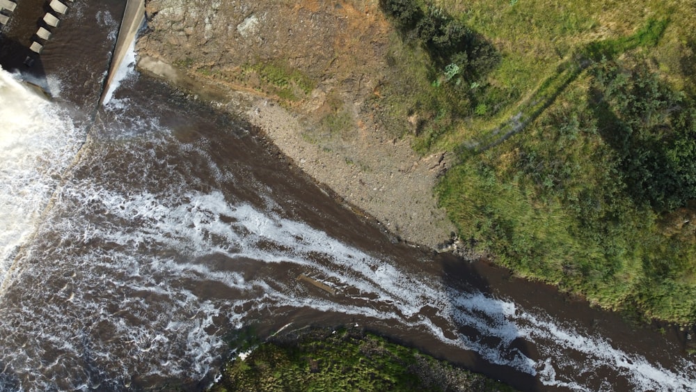 an aerial view of a river running through a forest