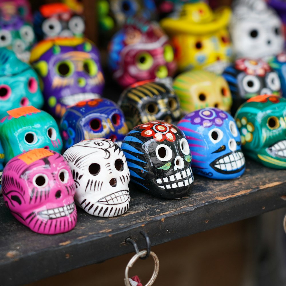 a bunch of colorful skulls sitting on a shelf