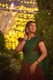 a woman in a green and brown dress talking on a cell phone