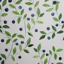 Pattern of watercolor-style illustrations featuring clusters of green leaves and small round blue berries on a light background. The leaves vary in shades of green, adding depth and texture, while the berries are depicted in different tones of blue, creating a harmonious and natural design.