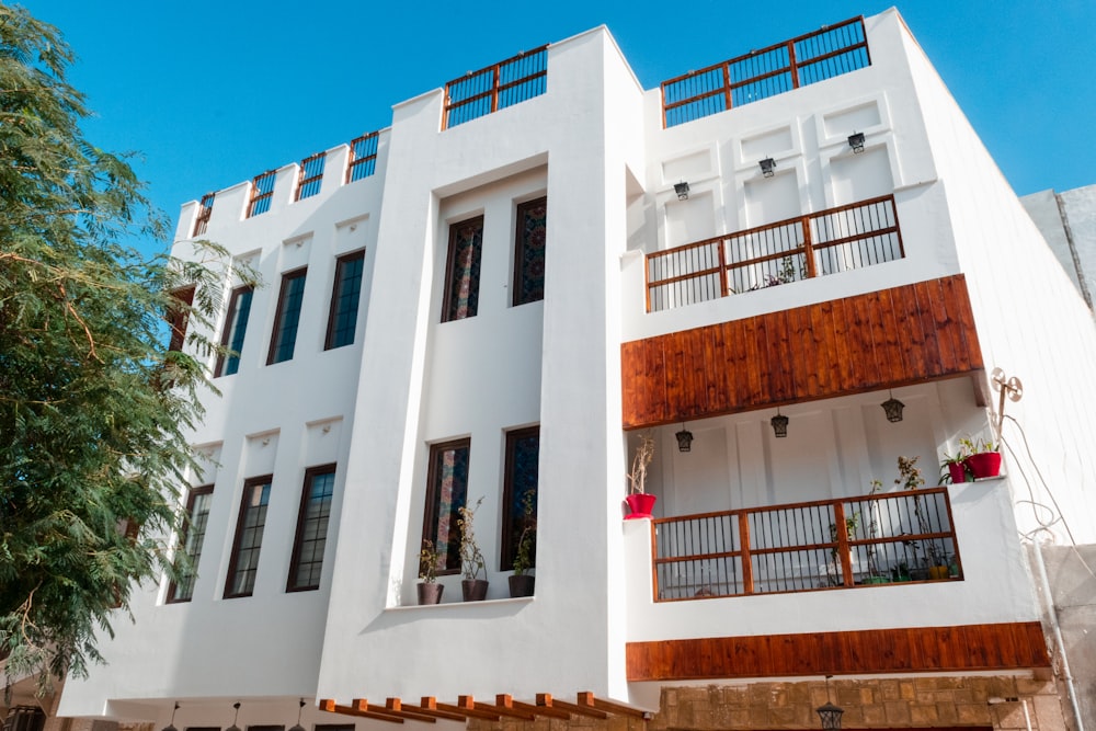 a large white building with wooden balconies