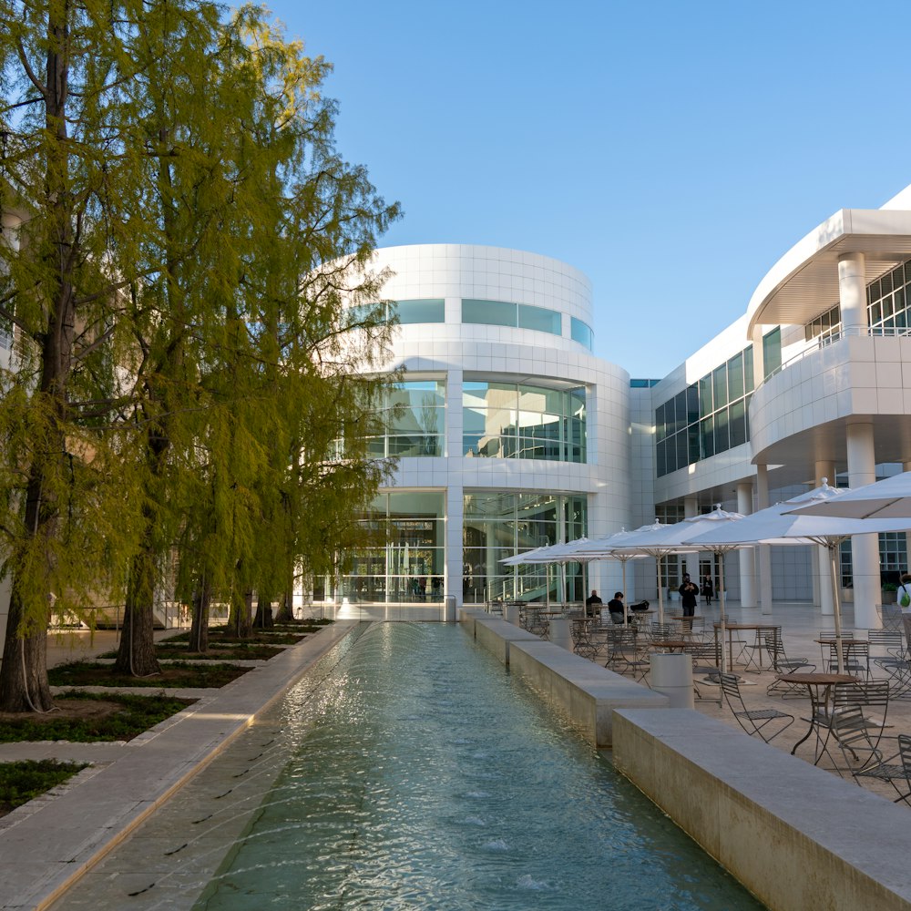 a large building with a pool of water in front of it