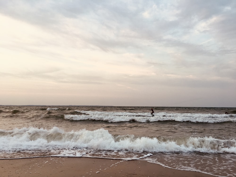 a person riding a surfboard on a wave in the ocean