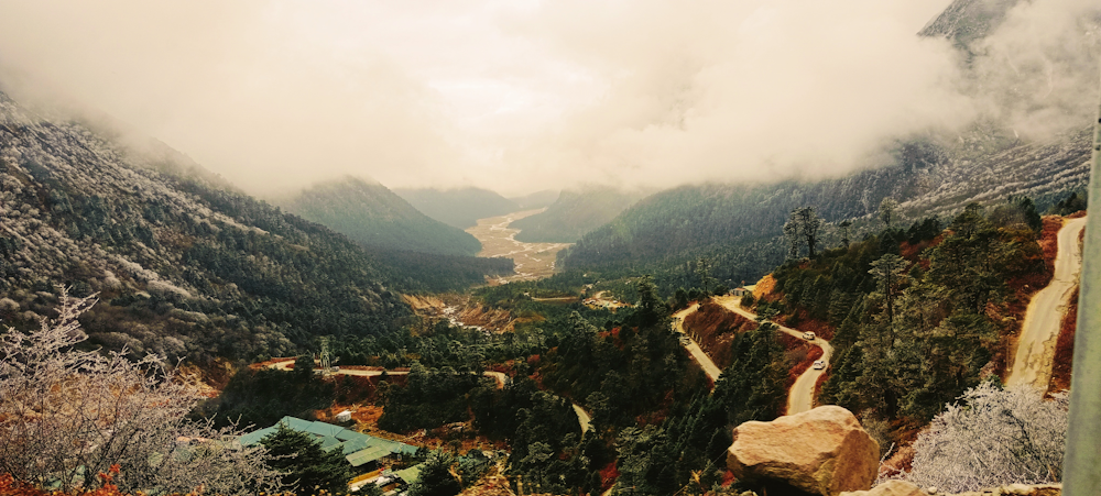 a scenic view of a valley with a river running through it