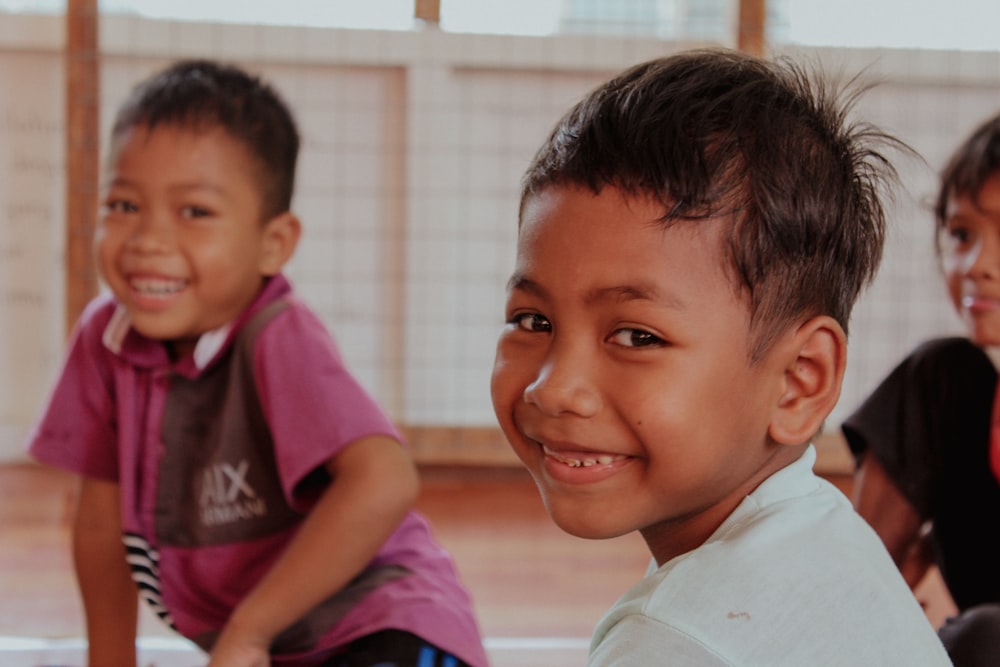 a group of young children sitting next to each other