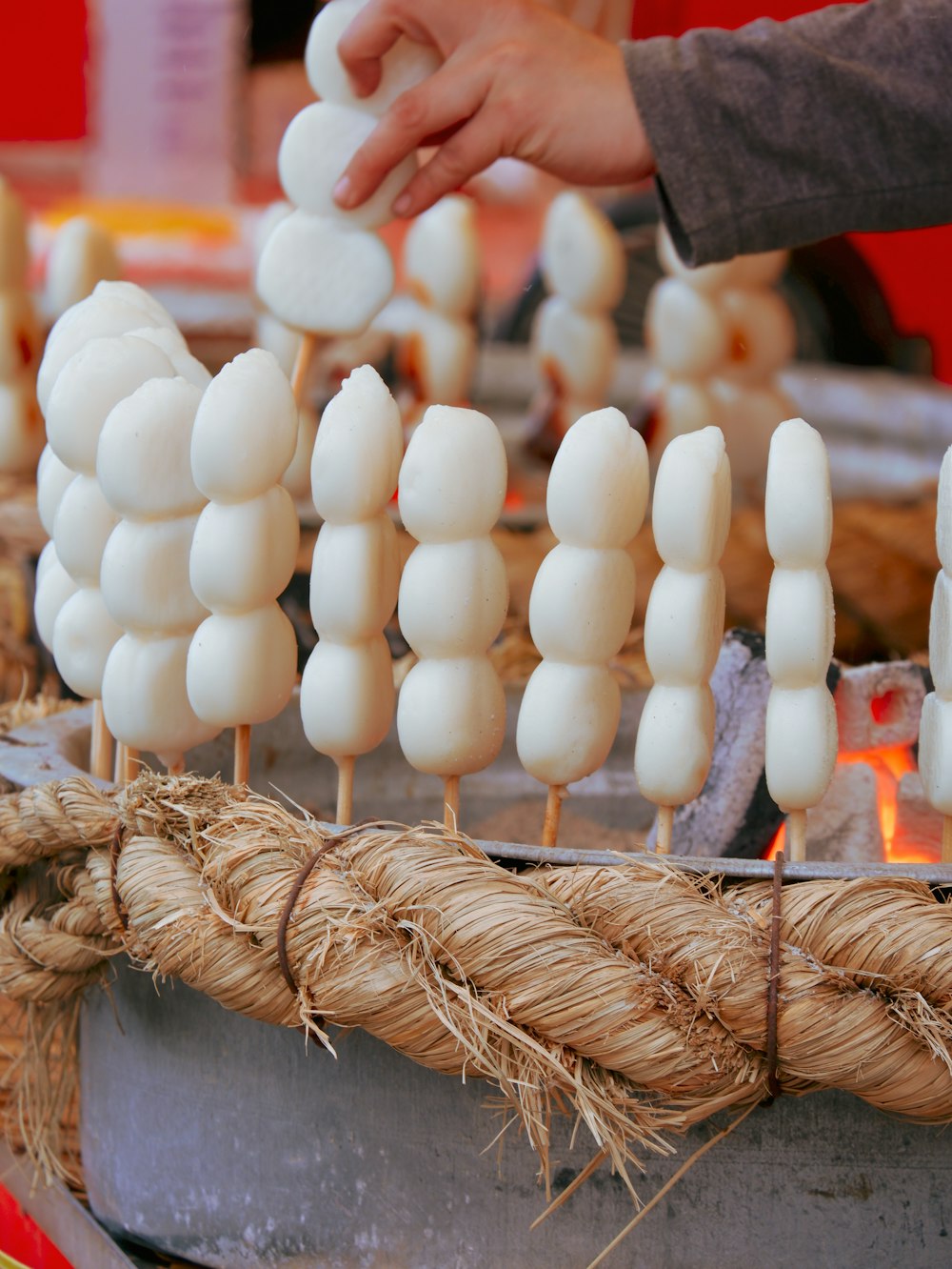 a bunch of marshmallows sitting on sticks on a table