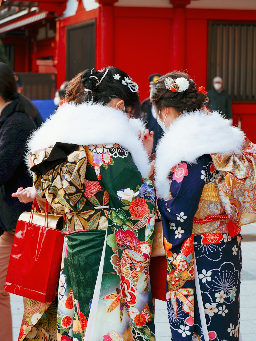 two women in kimonos walking down the street