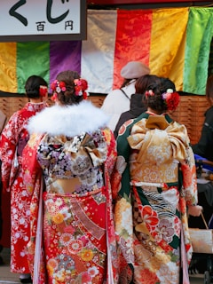 a couple of women walking down a street next to each other