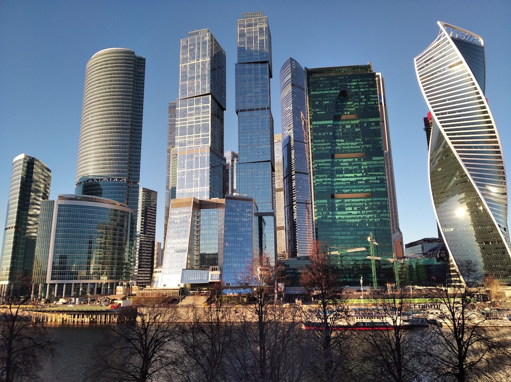 a group of tall buildings next to a body of water