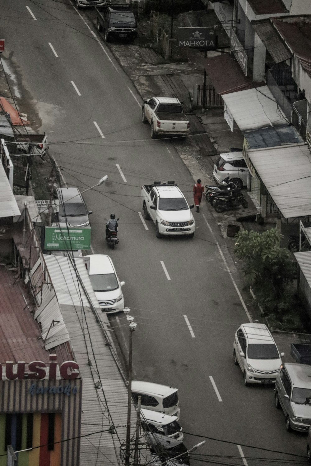 a city street filled with lots of traffic next to tall buildings