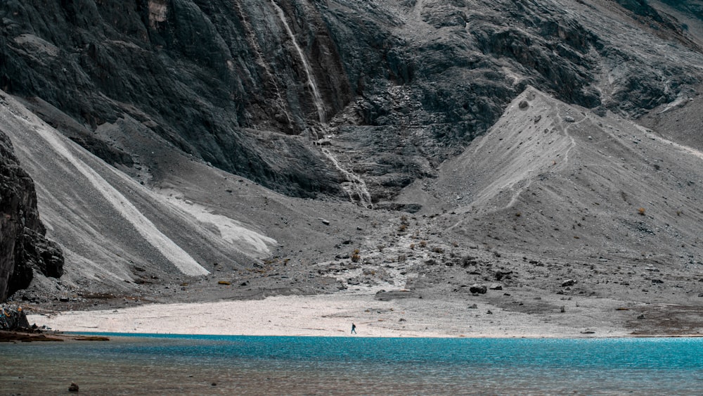 a mountain range with a body of water in the foreground