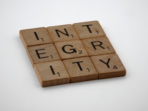 a scrabbled wooden block with the words integr city on it