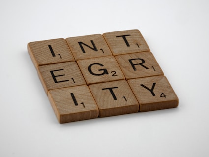 a scrabbled wooden block with the words integr city on it
