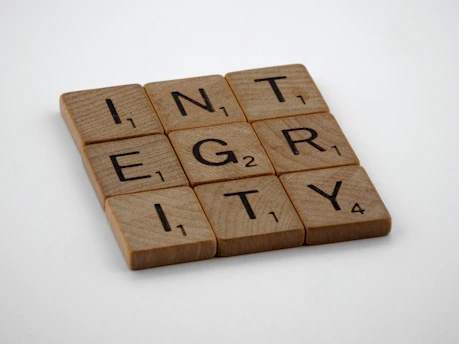 a scrabbled wooden block with the words integr city on it