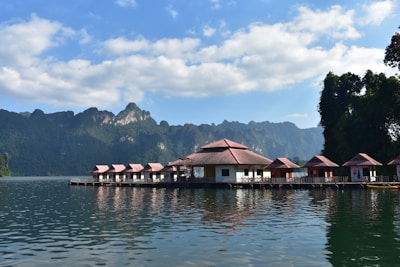 a row of huts sitting on top of a body of water
