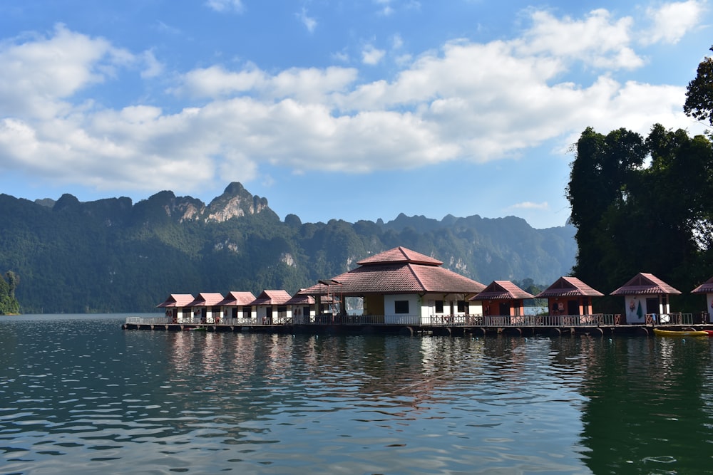 a row of huts sitting on top of a body of water