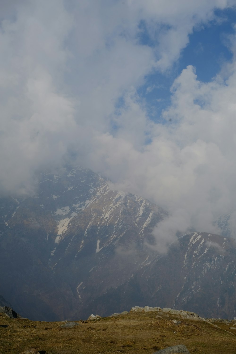 a view of a mountain range with clouds in the sky