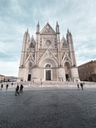 a group of people standing in front of a cathedral