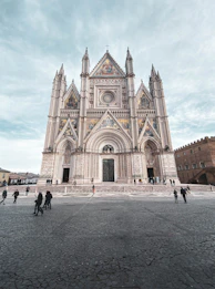 a group of people standing in front of a cathedral