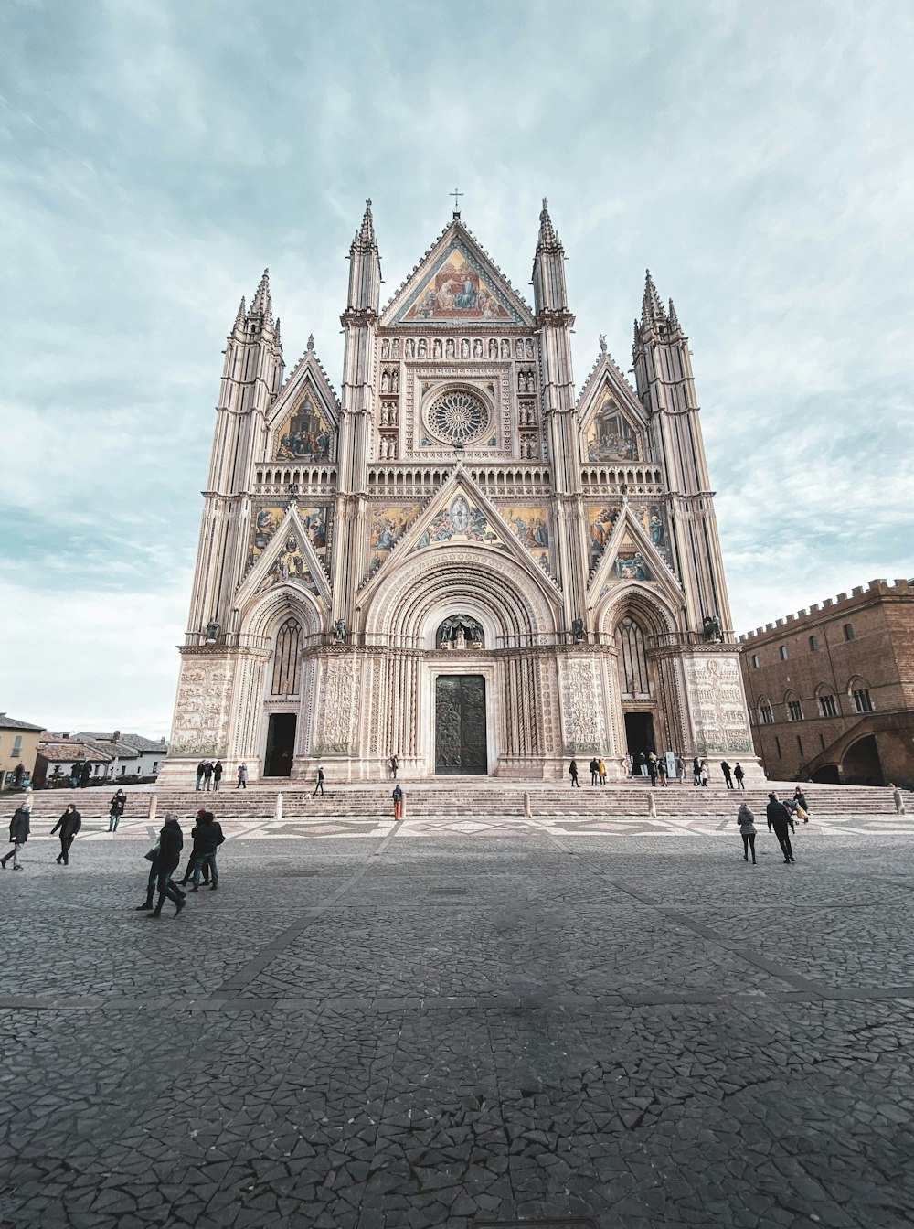 a group of people standing in front of a cathedral