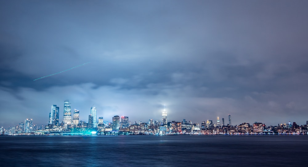 a view of a city at night from the water