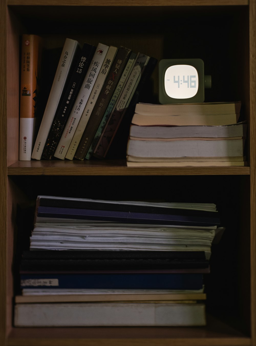 a book shelf filled with books and a clock