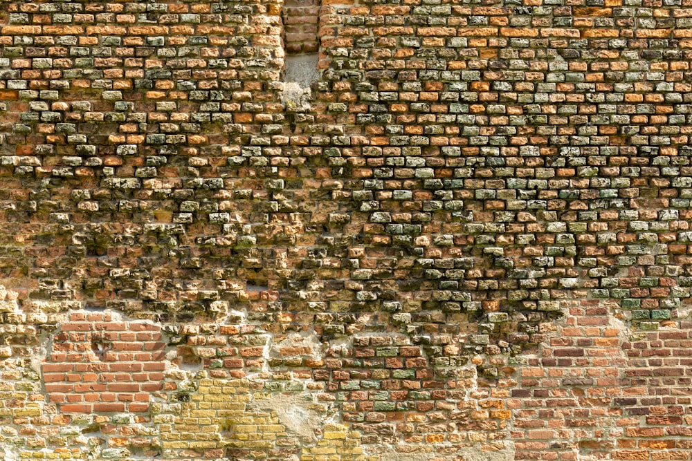 a brick wall with a window in the middle of it