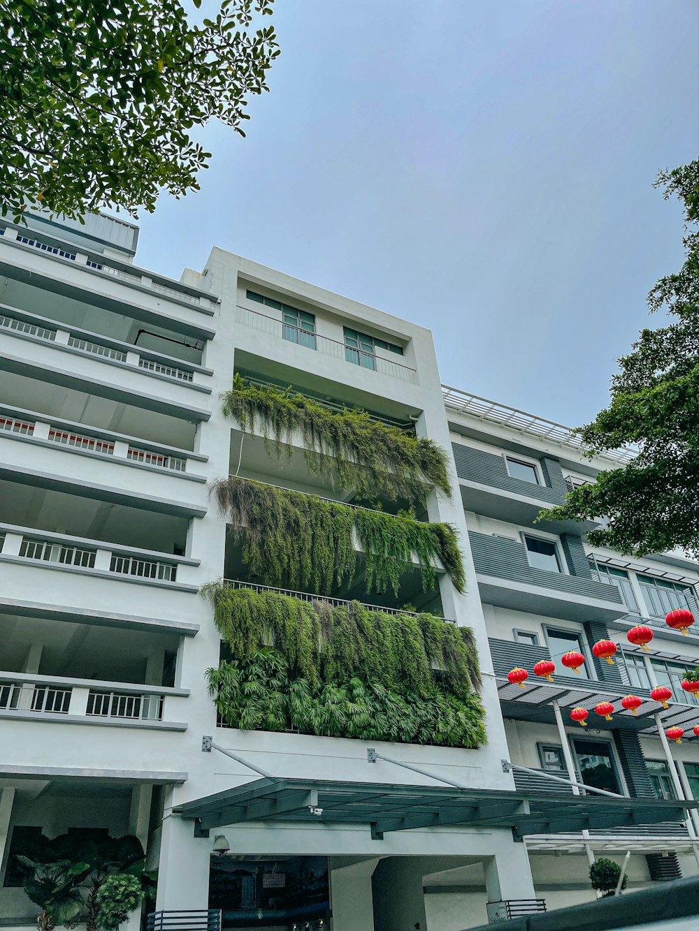 a building with a bunch of plants on the side of it
