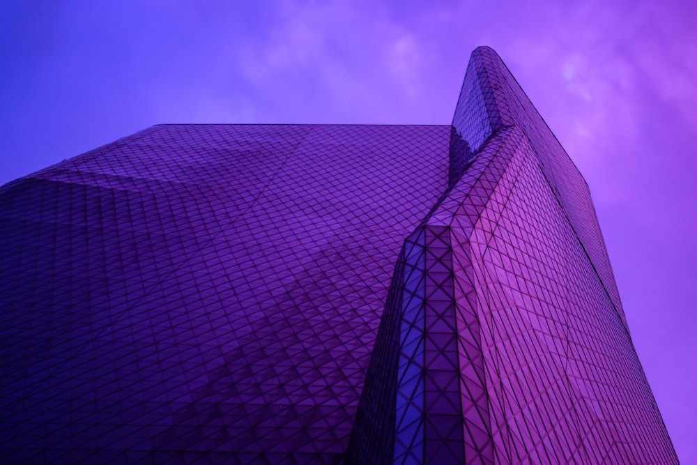 a very tall building with a purple sky in the background