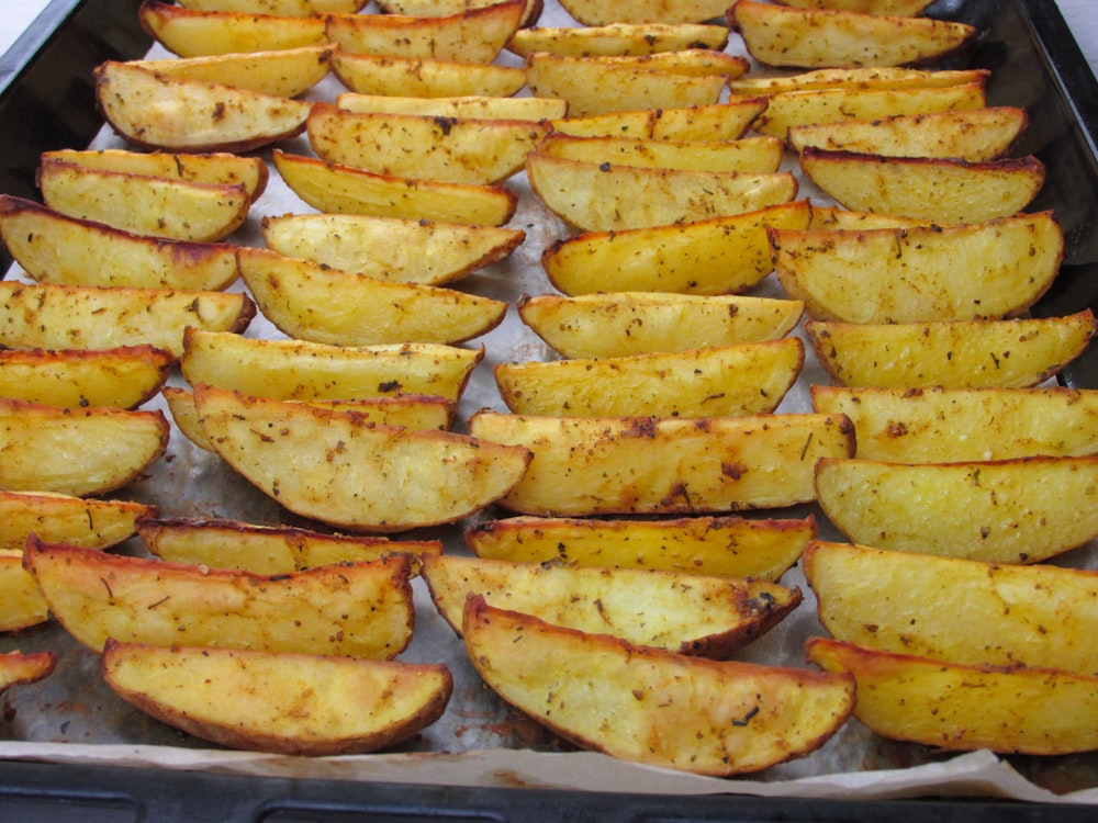 a pan filled with cooked potatoes on top of a table