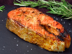 a piece of meat sitting on top of a black plate