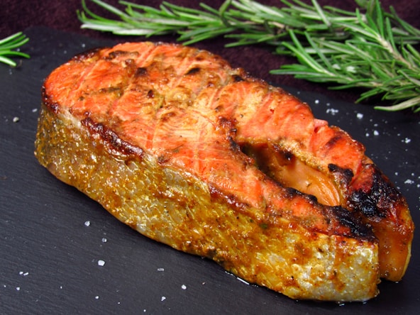 a piece of meat sitting on top of a black plate