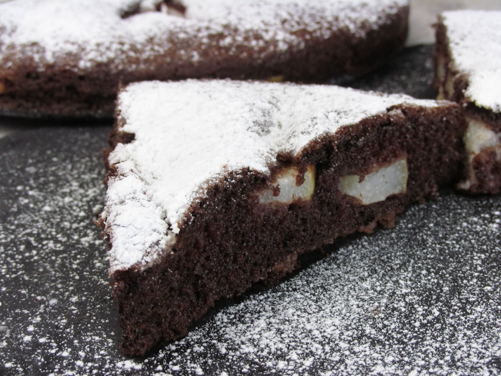 a piece of chocolate cake with powdered sugar on top