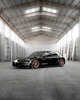 A sleek car interior with decorative accessories alongside heavy-duty mechanical equipment in a warehouse.