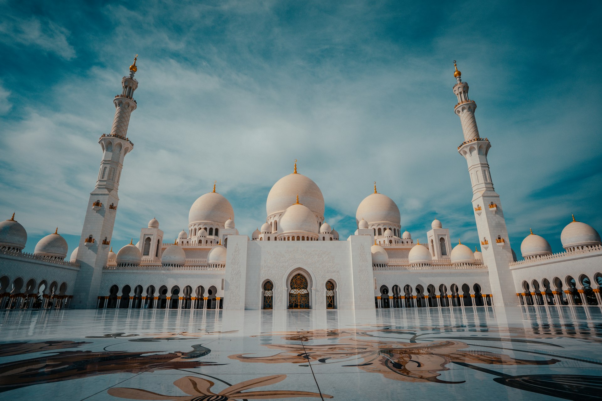 a large white building with many arches and domes
