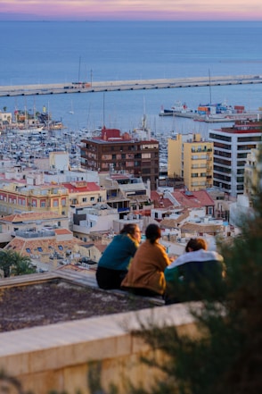 a group of people sitting on top of a roof
