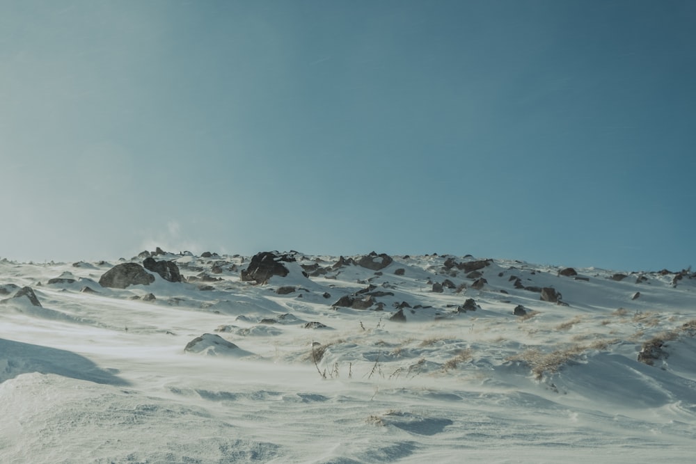 a man riding skis down a snow covered slope