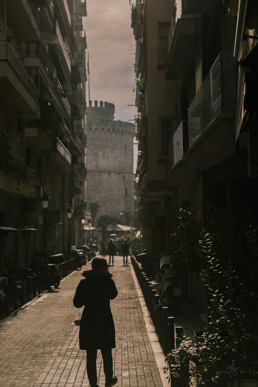 a person walking down a street in a city