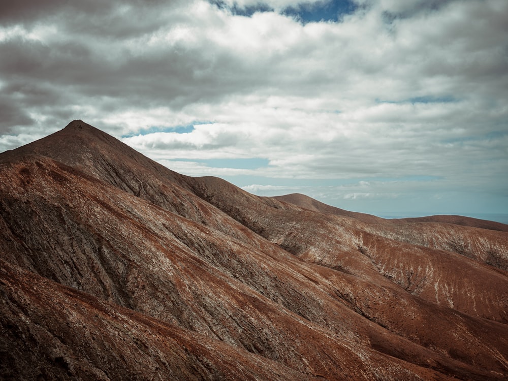 a view of a mountain range from the top of a hill