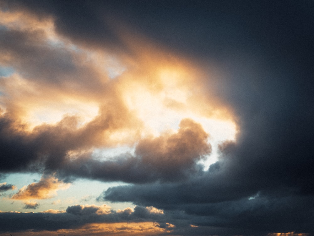 a plane is flying through a cloudy sky