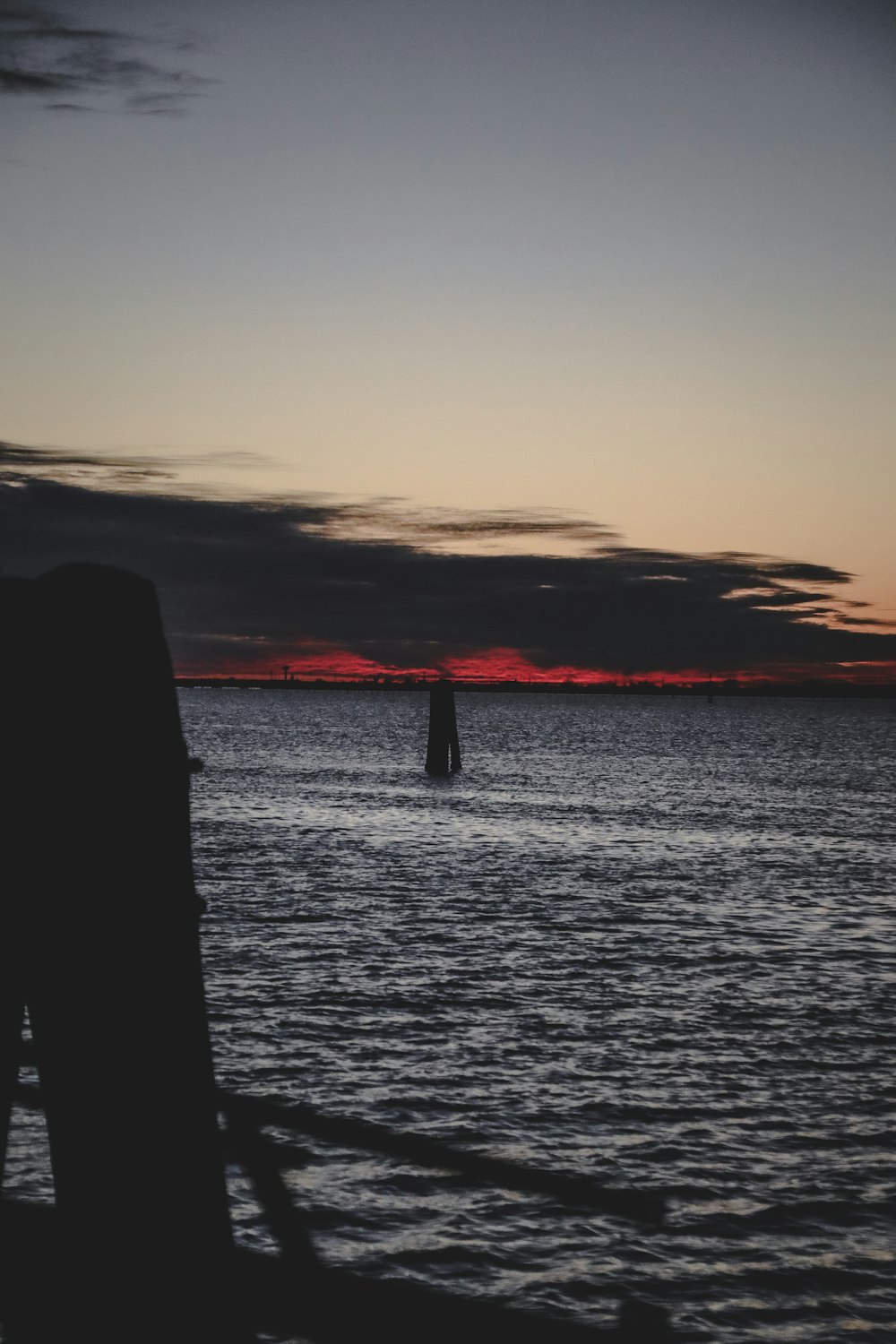 a boat in a body of water at sunset