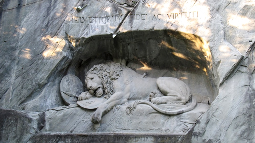 a statue of a lion in a cave