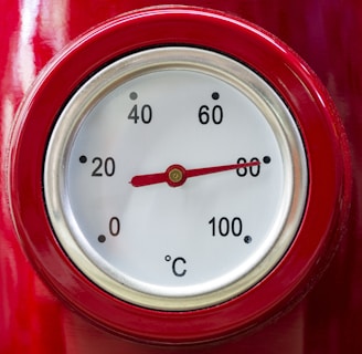 a close up of a thermometer on a red object